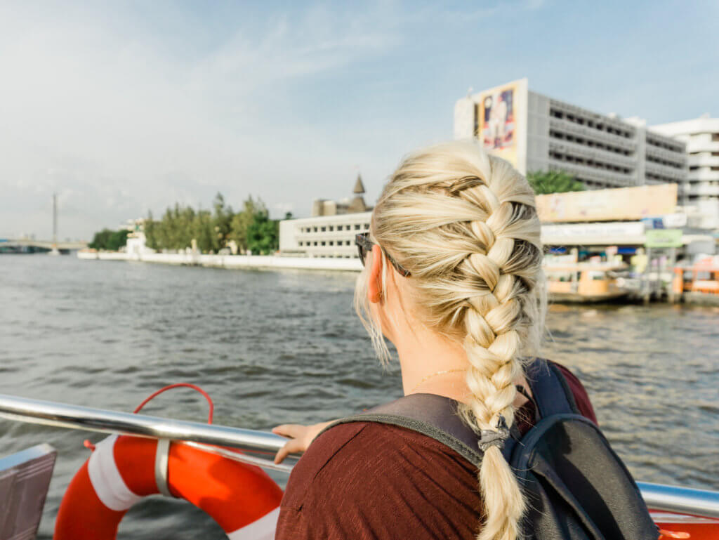 Cruising down the Chao Phraya River on hop on hop off boat in Bangkok, Thailand