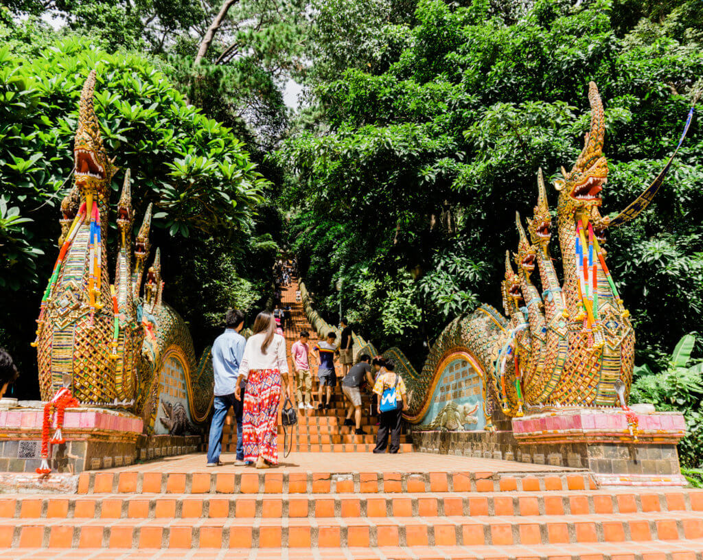 challenging stairs flanked by serpents to wat phrathat temple in chiang mai thailand