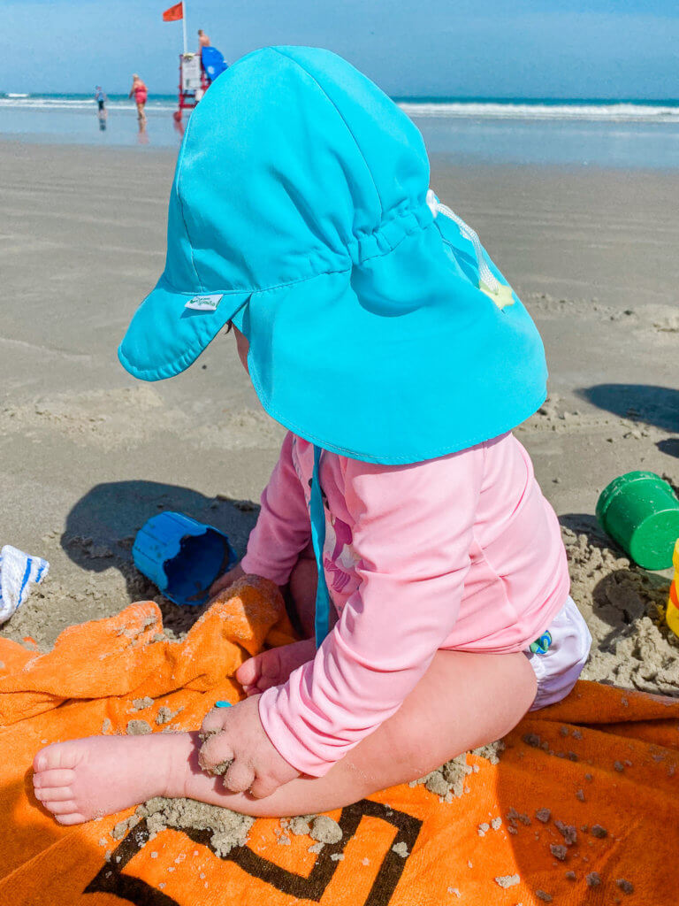 baby playing in the sand